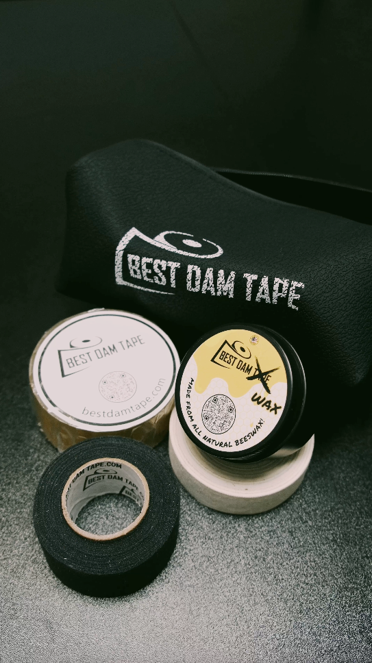 Black and white cloth tape, clear tape and Best Dam Wax beside a Best Dam Tape bag