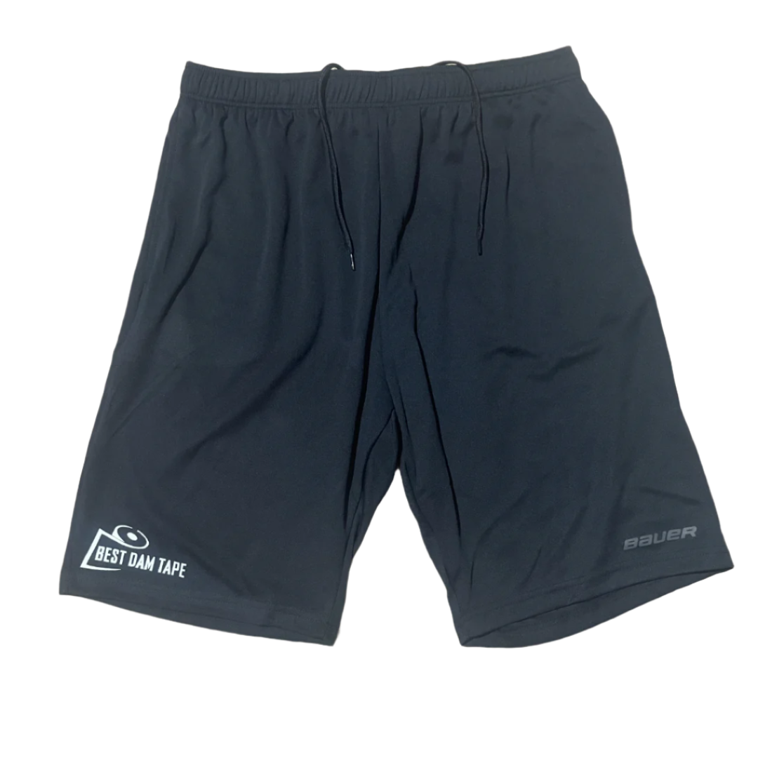 A pair of black athletic shorts with a logo on the left leg and a smaller text logo on the waistband.