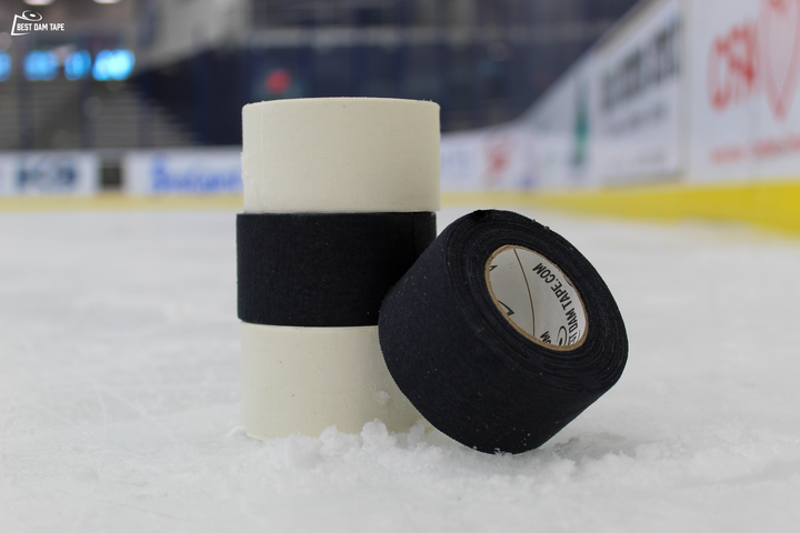 Two rolls of Best Dam double wide white cloth hockey tape on the ice