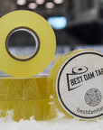 Two rolls of yellow tape with a visible brand logo on a blurred background
