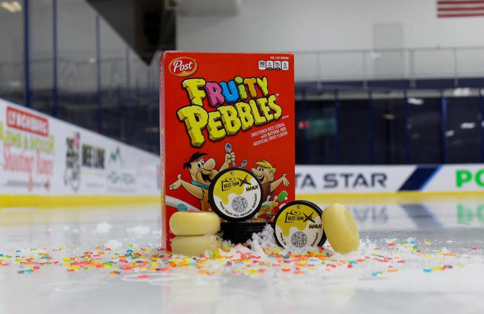 Best Dam Wax Fruity Pebbles scent tins next to a box of Fruity Pebbles cereal on the ice