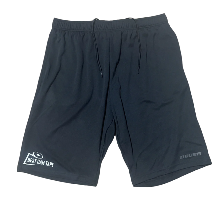 A pair of black athletic shorts with a logo on the left leg and a smaller text logo on the waistband.