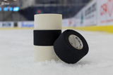 Two rolls of Best Dam double wide white cloth hockey tape on the ice