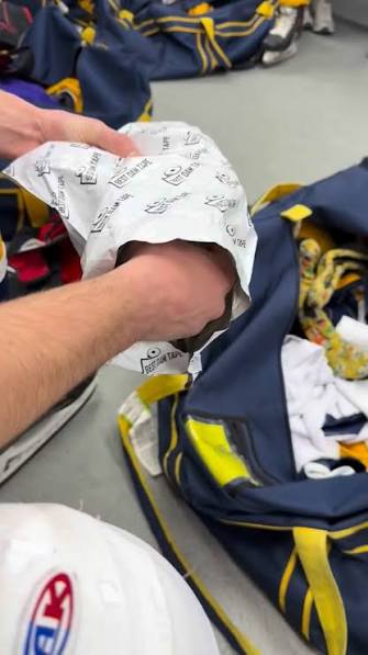 Pulling a Best Dam Tape bag out of a hockey bag