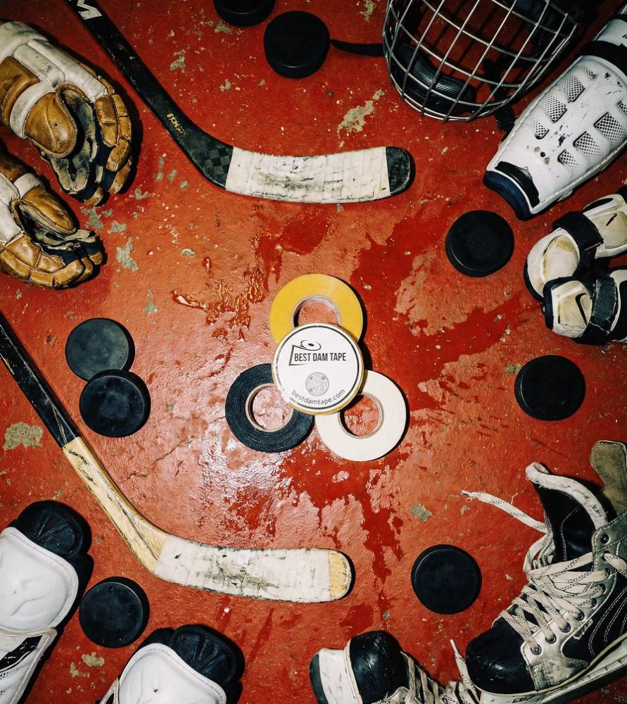 Best Dam clear, cloth and wax laid out with sticks, pucks and gear